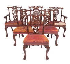 A set of six carved mahogany and leather upholstered dining chairs in George III Chippendale style,