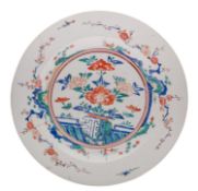A large Japanese Kakiemon-style charger painted in bright enamels with rockwork, a fence,