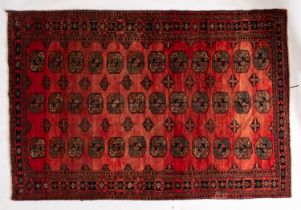 A Turkoman rug, the rose field with three rows of quartered guls,