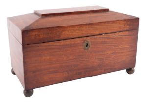 An early Victorian satin mahogany tea caddy, mid 19th century; of sarcophagus form,