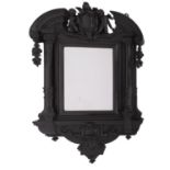An Italian carved and ebonised wood framed wall mirror in Baroque style,