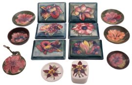 Fourteen pieces of Walter and John Moorcroft pottery comprising six pin trays, a small plaque,