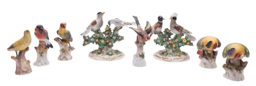 A pair of German porcelain bocage bird groups together with two pairs of single bird figures and