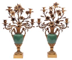 A pair of French gilt bronze and green porcelain four light candelabra,