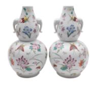A pair of Chinese porcelain double gourd vases, with elephant mask handles,