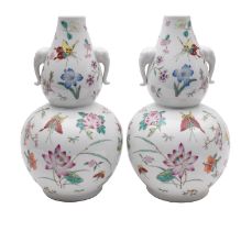 A pair of Chinese porcelain double gourd vases, with elephant mask handles,