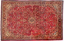 A Bidjar carpet, the wine cartouche field with a central shaded geometric flowerhead pole medallion,