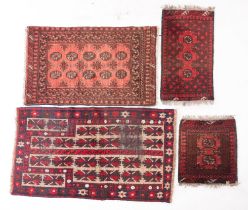 An Afghanistan rug of Turkoman design, the rose field with two rows of quartered octagons,