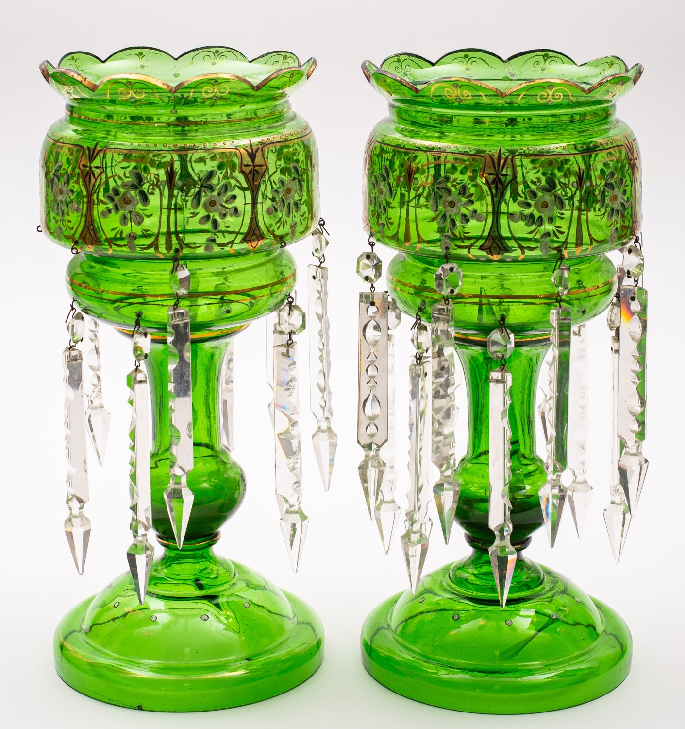 A pair of green glass table lustres with gilt and enamelled decoration,