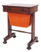 A Regency rosewood sewing table, circa 1815; the drawer with twin turned knob handles,