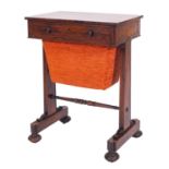 A Regency rosewood sewing table, circa 1815; the drawer with twin turned knob handles,