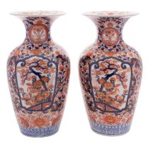A pair of Japanese Imari vases each with waisted neck and flared rim,