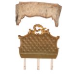 A carved giltwood and green upholstered headboard in Louis XV taste,