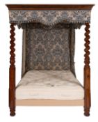 A mahogany and fabric adorned four-post bed,