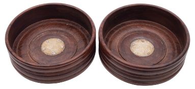A pair of Elizabeth II silver mounted mahogany coasters of conventional turned form,