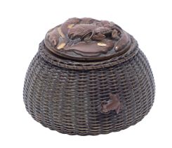 A Japanese patinated mixed metal inkwell in the form of a wicker lobster pot,