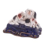 A Staffordshire porcelain 'spaniel family' inkwell in the form of a spaniel and two pups,