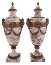 A pair of gilt metal mounted marble side urns in Neoclassical taste,