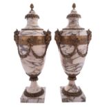 A pair of gilt metal mounted marble side urns in Neoclassical taste,