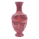 A Chinese cinnabar lacquer vase, figure in a garden, late Qing Dynasty, 24cm high.