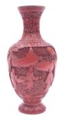 A Chinese cinnabar lacquer vase, figure in a garden, late Qing Dynasty, 24cm high.
