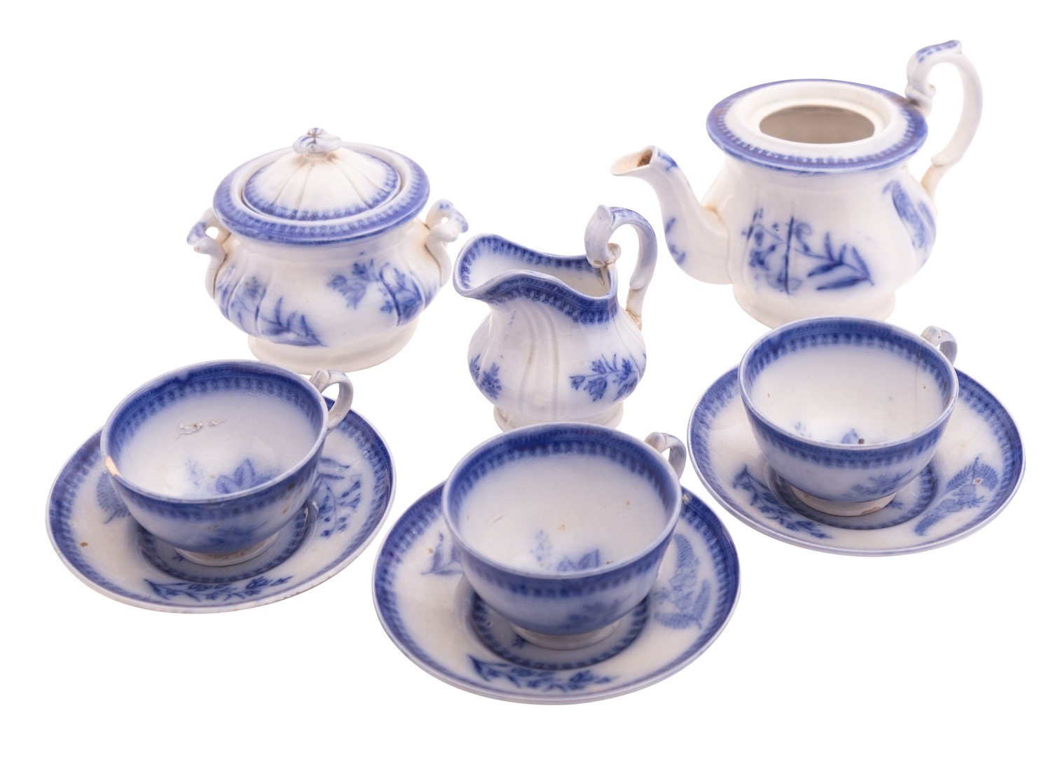 A Davenport pottery nursery tea set, decorated in flow blue with foliate sprigs,