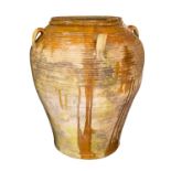 A partially glazed terracotta garden urn,