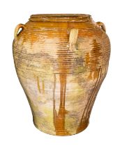 A partially glazed terracotta garden urn,