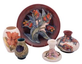 Five pieces of John Moorcroft pottery, comprising a Tulip pattern plate and vase,