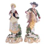 A pair of Continental porcelain figures modelled as a musician with a dog at foot,