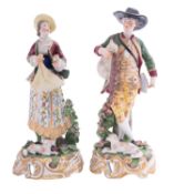 A pair of Continental porcelain figures modelled as a musician with a dog at foot,