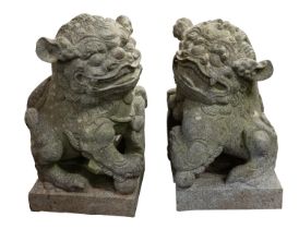 A pair of carved schist lion dogs, probably Indonesian,