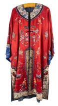 A Chinese hand-embroidered red silk robe, with floral and figural decoration,