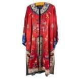 A Chinese hand-embroidered red silk robe, with floral and figural decoration,