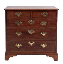 A George III stained mahogany chest of drawers, late 18th century; the top with moulded edges,