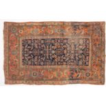 A Kurdish rug, the indigo herati field enclosed by a main brick red floral,