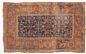 A Kurdish rug, the indigo herati field enclosed by a main brick red floral,