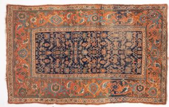 A Kurdish rug, the indigo herati field enclosed by a main brick red floral,