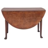 A George II oak drop leaf table, circa 1740, the oval top with twin drop leaves,