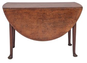 A George II oak drop leaf table, circa 1740, the oval top with twin drop leaves,