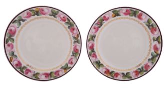 A pair of early 19th century creamware plates the rims painted with pink rose sprays within