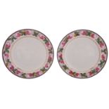 A pair of early 19th century creamware plates the rims painted with pink rose sprays within
