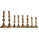 Three pairs of Victorian brass candlesticks,