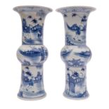 A pair of Chinese 'Gu' form vases, painted in blue with figures in fenced gardens, 20th century,