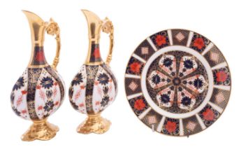 A pair of Royal Crown Derby ewers of flattened pedestal form decorated with an Imari pattern,