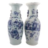 A pair of Chinese celadon ground baluster vases with lion-dog handles,