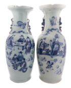 A pair of Chinese celadon ground baluster vases with lion-dog handles,