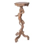 A north Italian carved limewood torchere stand, in Baroque style,