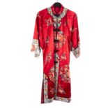 A Chinese hand-embroidered red silk robe, with floral decoration,