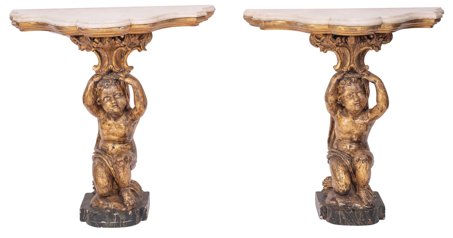 A pair of Italian marble topped, carved and giltwood console tables in Rococo style,